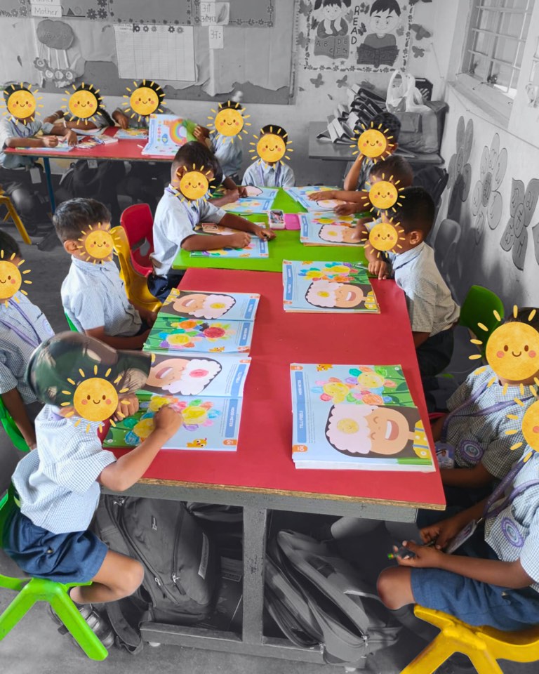 Hippocampus children working through Tilli activity books at a classroom table