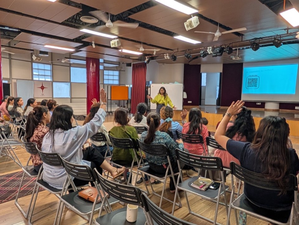Teachers raising hands during a Tilli training session